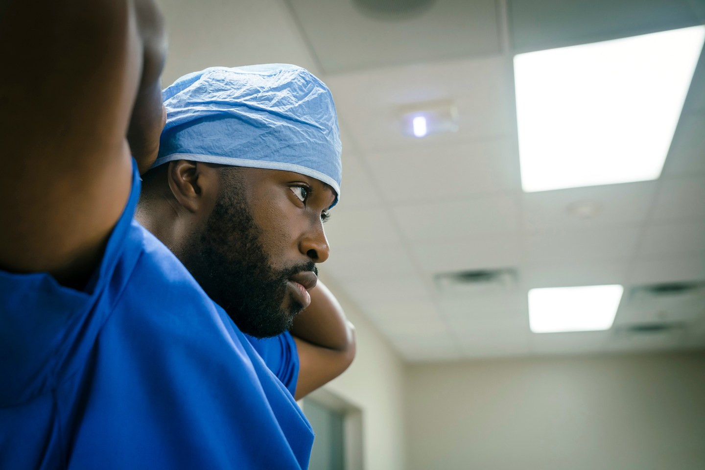Black doctor wearing surgical cap