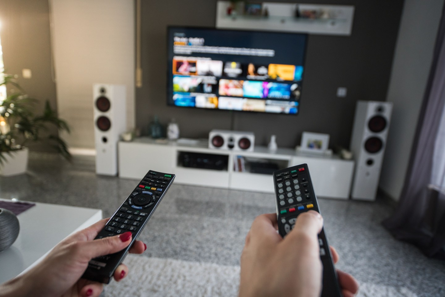 Man and woman with television remote control
