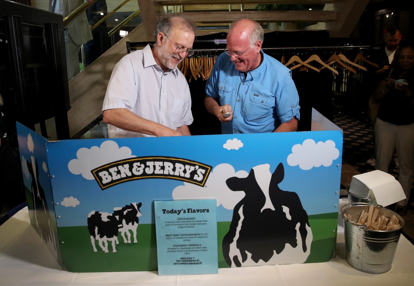 Ben & Jerry's co-founders Ben Cohen (R) and Jerry Greenfield (L) serve ice cream following a press conference announcing a new flavor, Justice Remix'd, September 03, 2019 in Washington, DC.