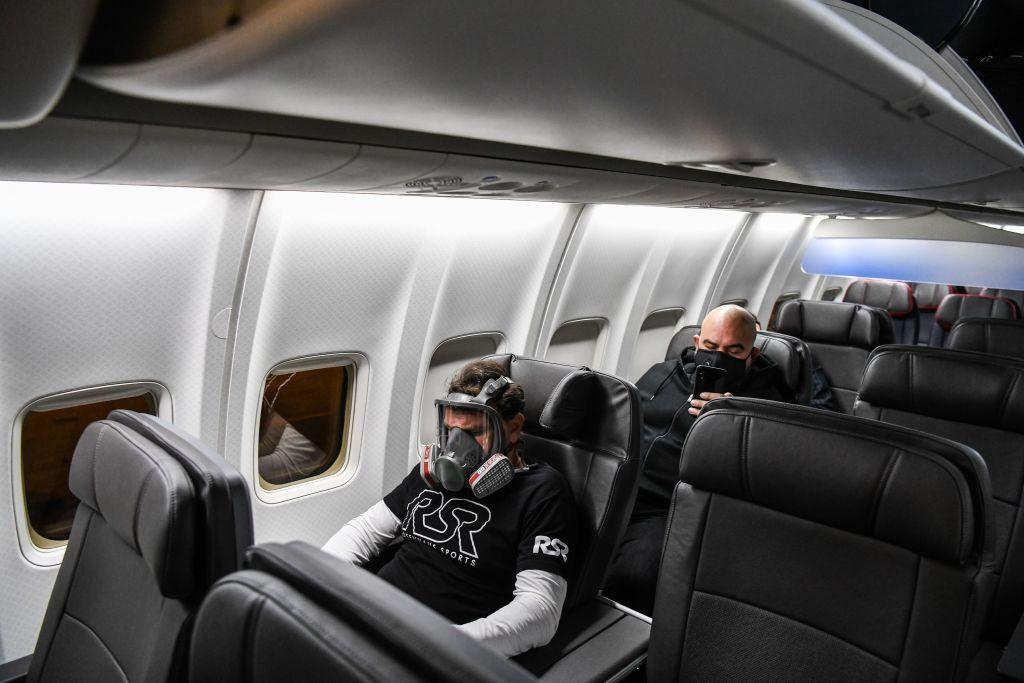 man in gasmask on airline flight