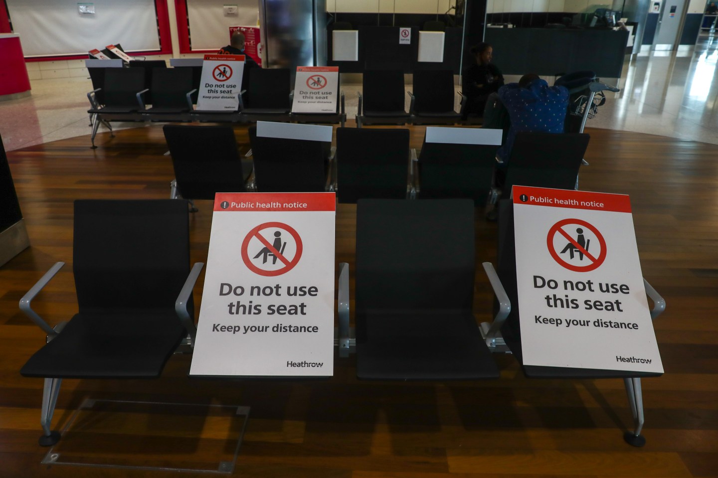 Social distancing notices sit on chairs in Terminal 2 at London Heathrow Airport in London, U.K., on Monday, June 8, 2020.