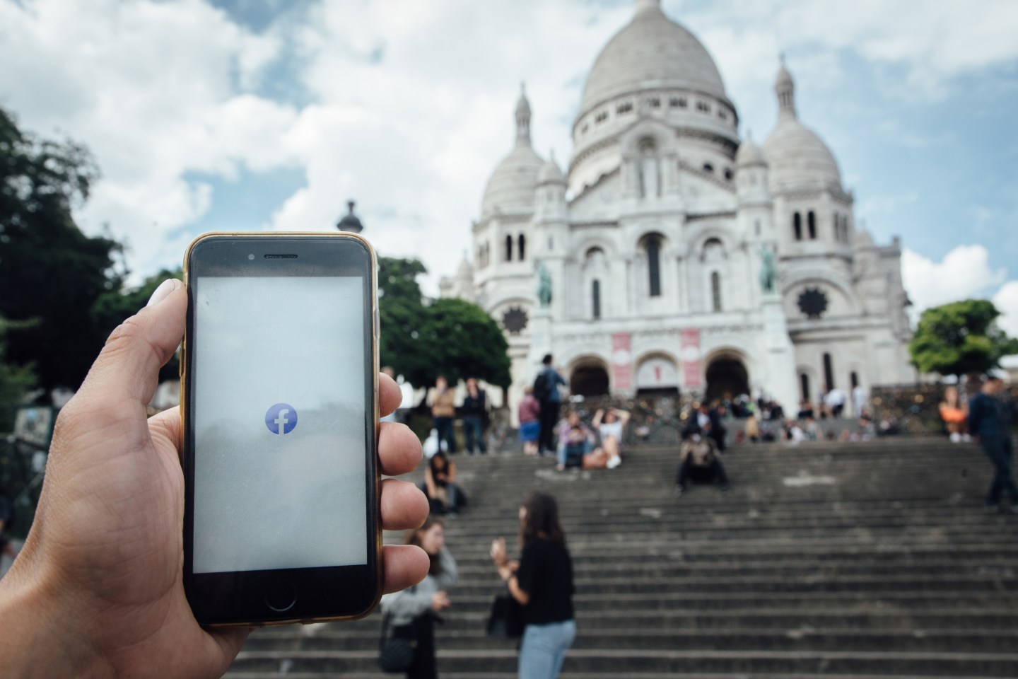 The Facebook Inc. app is displayed on a Apple Inc. smartphone near Le Sacre Coeur basilica in this arranged photograph in Paris, France, on Wednesday, June 10, 2020. 