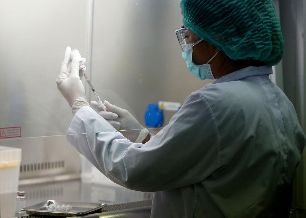 A researcher wearing a face mask and gloves as a preventive