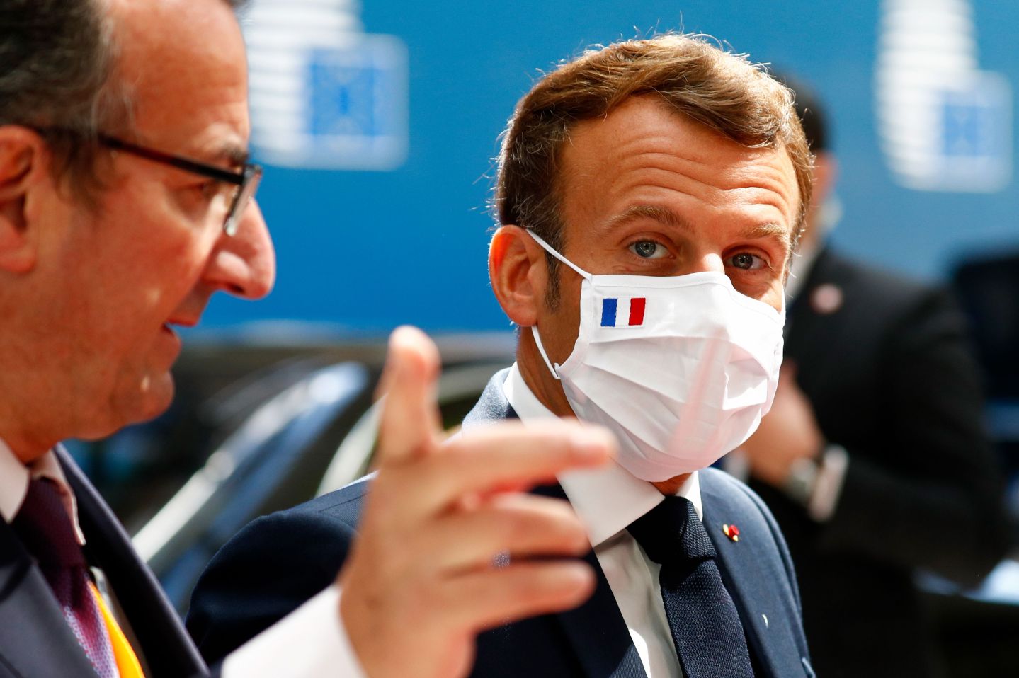 France's President Emmanuel Macron, wearing a protective face mask, looks on as he arrives for a meeting during an EU summit at the European Council building in Brussels, on July 20, 2020.