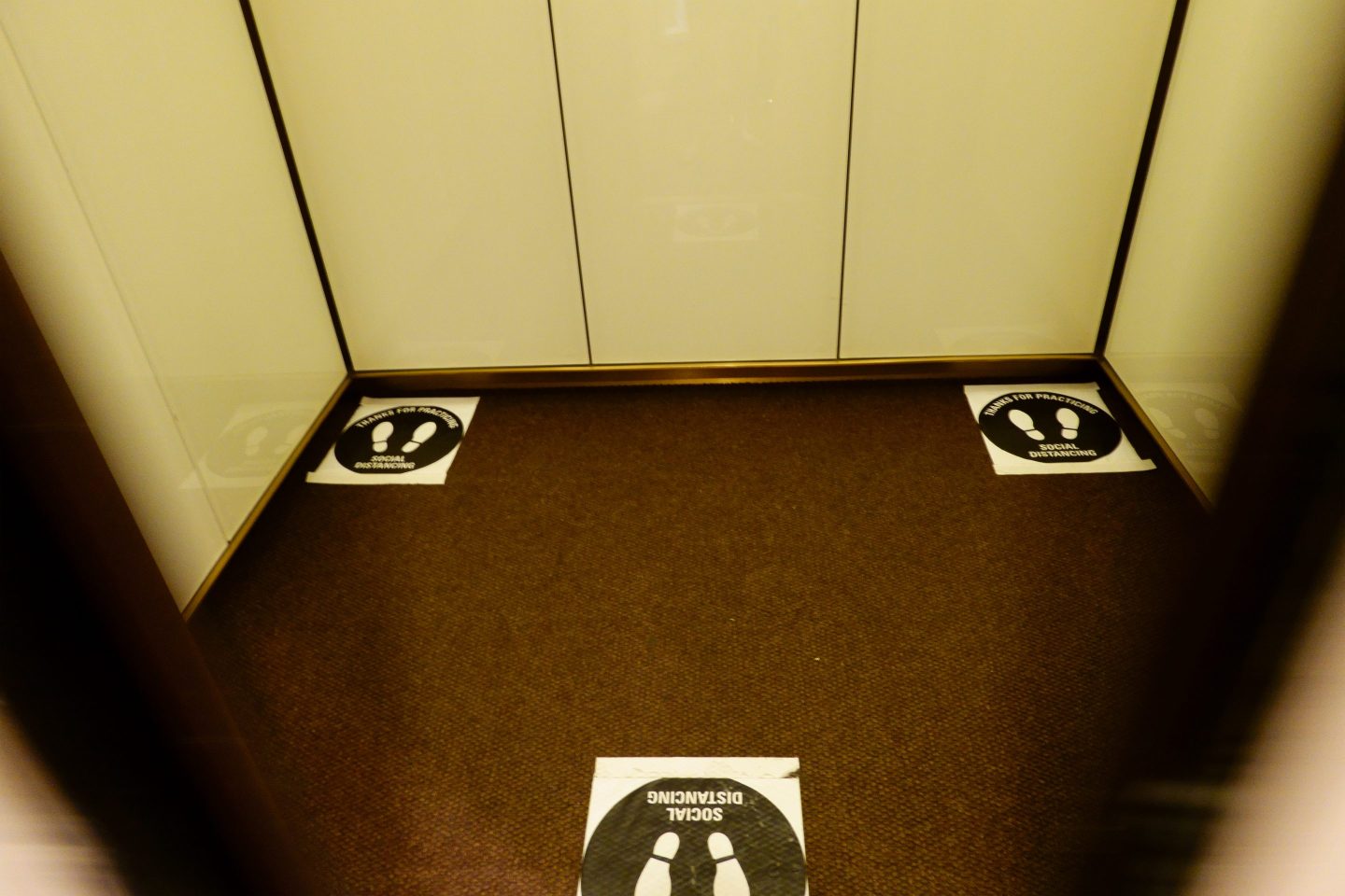 Footprint stickers designed to encourage social distancing in a New York City office elevator. (Photo by: Joan Slatkin/Education Images/Universal Images Group via Getty Images)