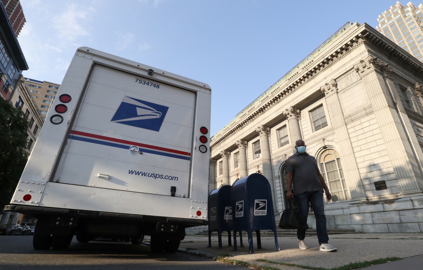 A United States Postal Service truck and mailbox outside a post office in Jersey City, N.J. "Mail-in voting has demonstrated success," writes Steve Weisman, "when President Trump and his party are not actively working to undermine the process." (Photo by Gary Hershorn/Getty Images)