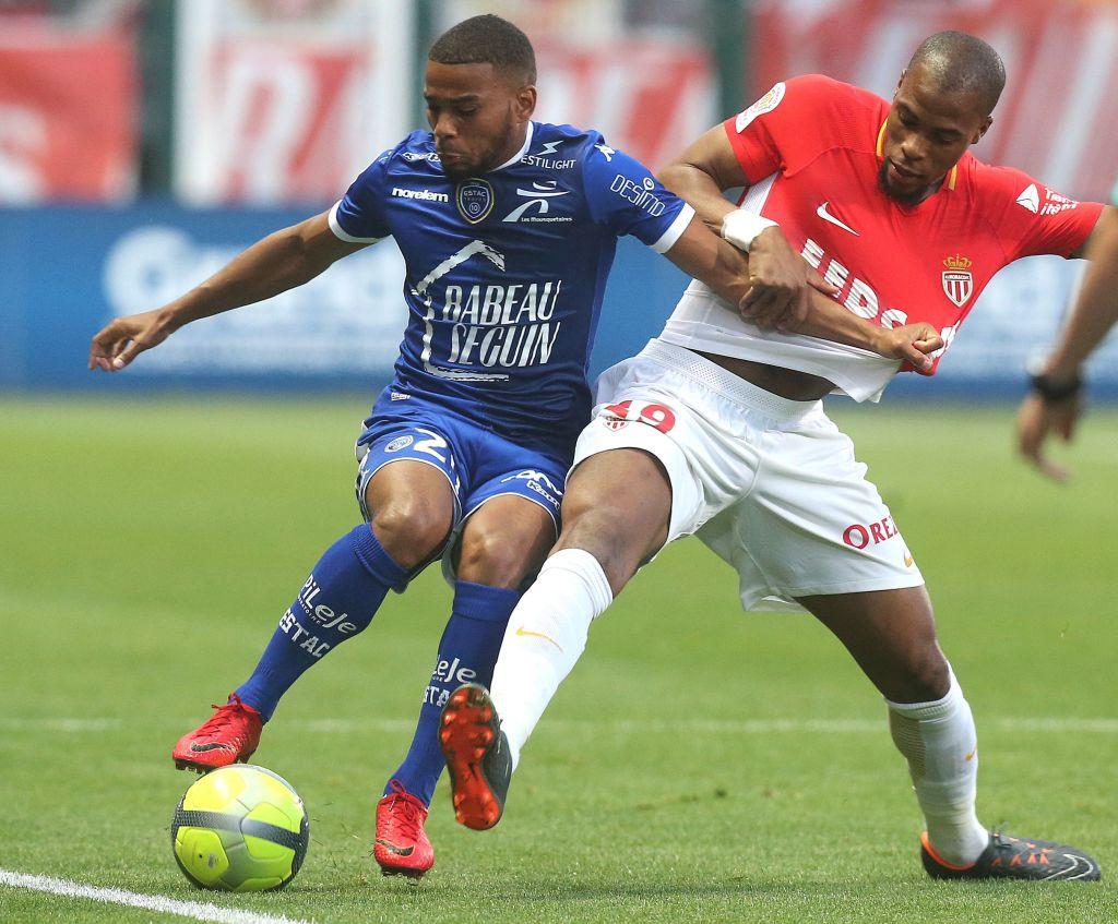 Two soccer players fight for the ball.