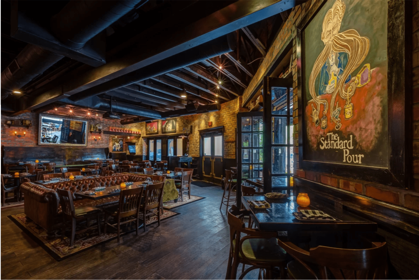 A painting inside dallas bar, The Standard Pour, a paint depicts a man using his beard to mix drinks.