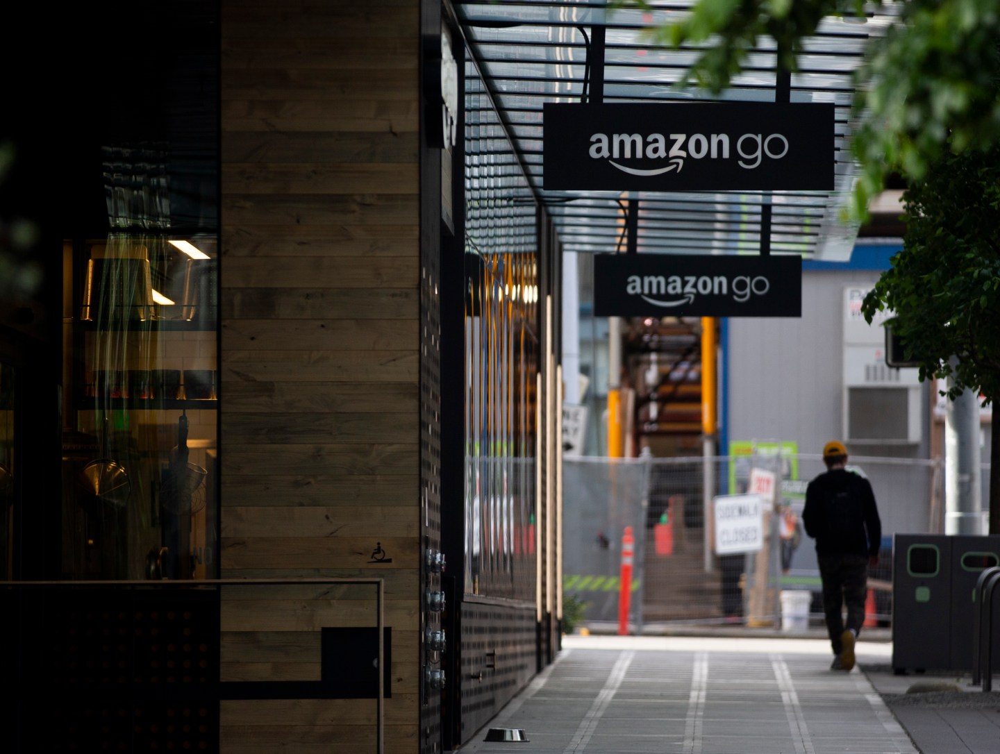 A person walks by an Amazon Go store at the downtown Amazon campus on April 30, 2020 in Seattle, Wash.
