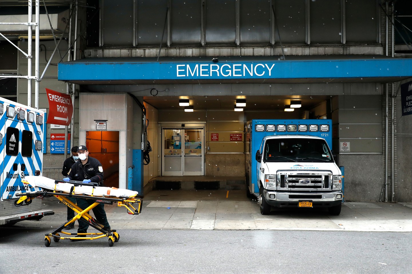 Emergency Medical Technicians move a gurney out of the emergency entrance into an ambulance at Mt. Sinai-Beth Israel Hospital amid coronavirus crisis.
John Lamparski—SOPA Image/LightRocket/Getty Images