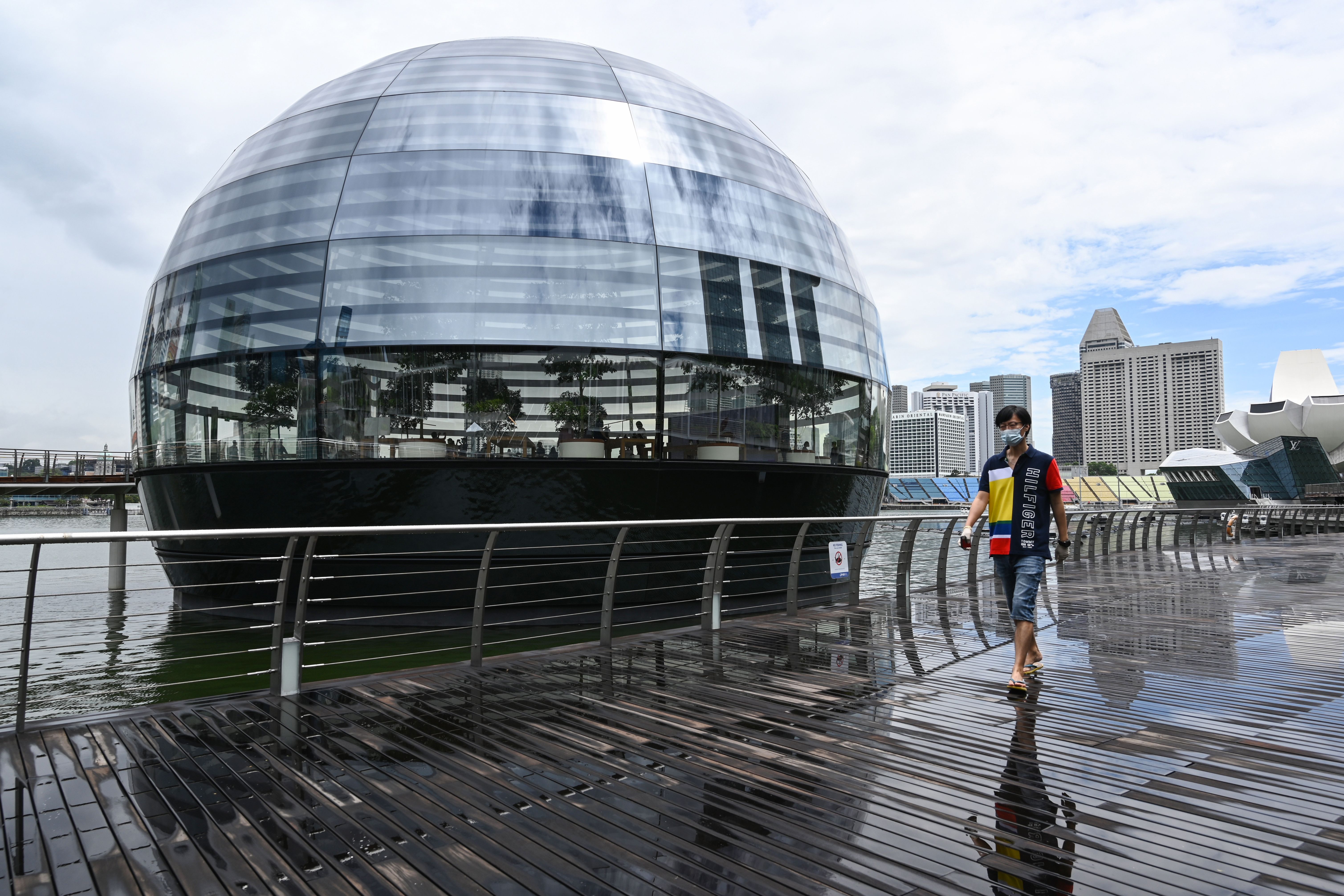 A man walks past Apple's third retail store during its opening at Marina Bay Sands in Singapore on September 10, 2020. (Photo by Roslan RAHMAN / AFP) (Photo by ROSLAN RAHMAN/AFP via Getty Images)