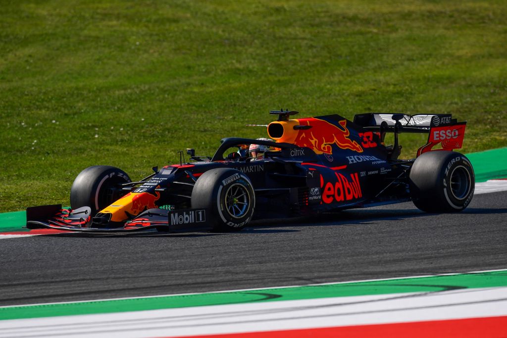 Photo of Aston Martin Red Bull Racing F1 car on the track.