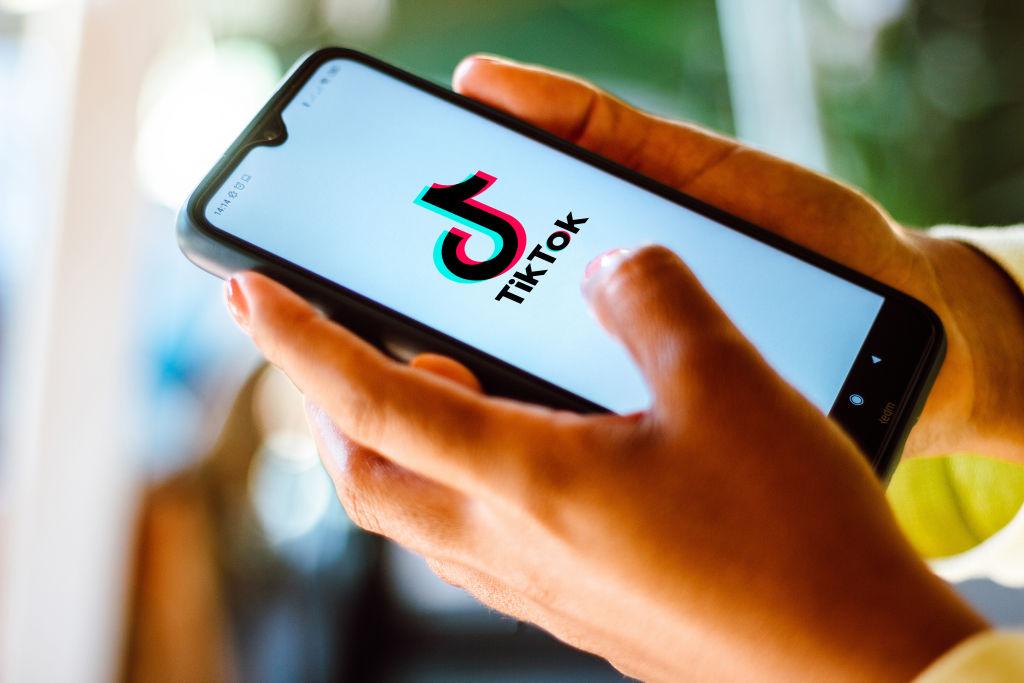 In this photo illustration the TikTok logo seen displayed on