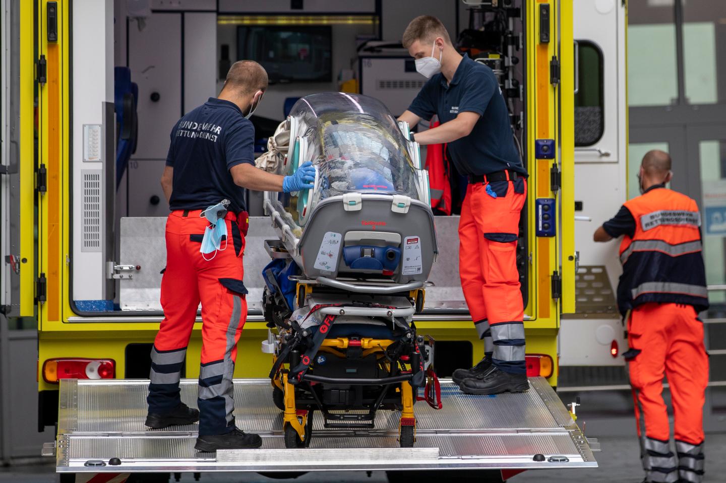 German army emergency personnel load portable isolation unit (Epi Shuttle) into their ambulance that was used to transport Russian opposition figure Alexei Navalny at Charite hospital on August 22, 2020 in Berlin, Germany.