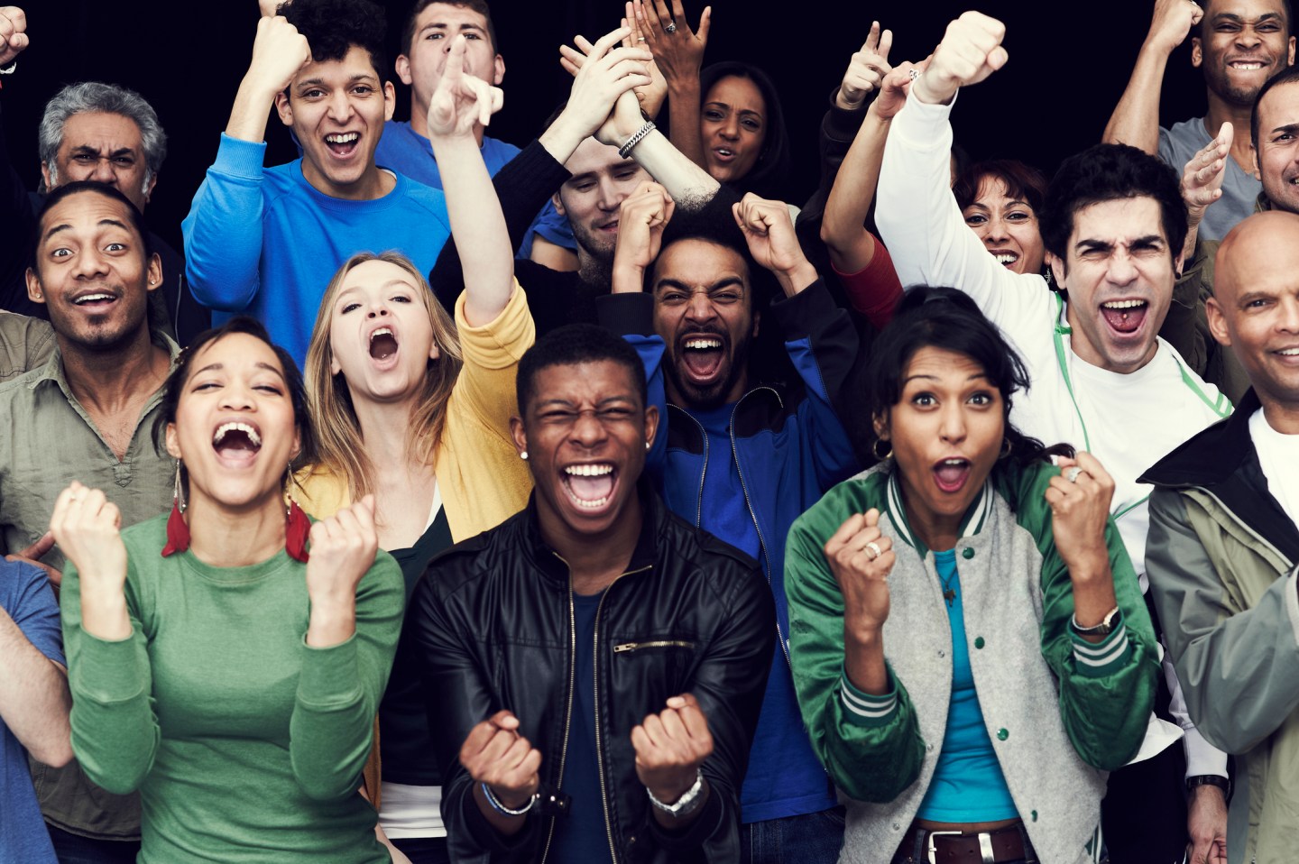 Photo of a diverse group of men and women cheering.