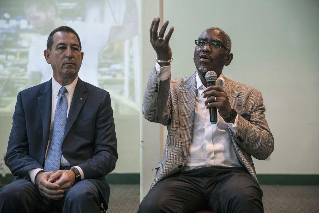 Representative Gregory Meeks, a Democrat from New York, right, speaks while Comptroller of the Currency Joseph Otting listens during a nationwide bus tour in the Jamaica neighborhood of the Queens borough of New York, U.S., on Wednesday, Aug. 21, 2019. Otting's five-city bus tour is aimed to sell his vision for a rewrite of the rules governing the Community Reinvestment Act, a 1977 anti-redlining law aimed at boosting banks' lending and investments in low- to moderate-income communities.