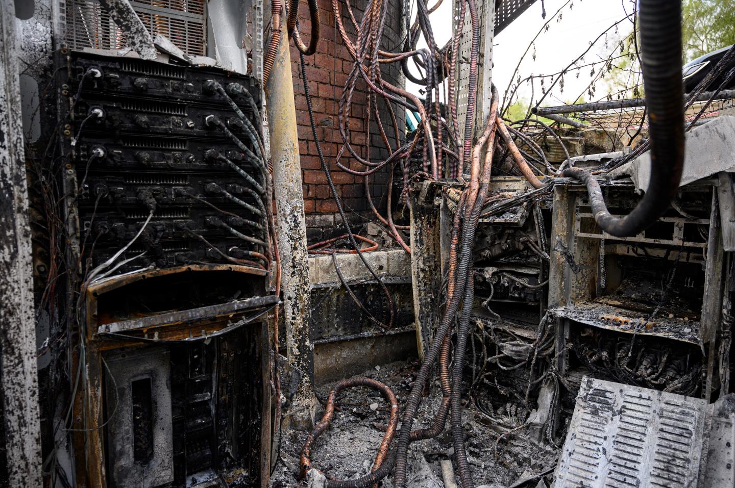 Damaged cabling and telecommunications equipment is pictured following a fire at a phone mast, attached to the chimney at the converted Fearnleys Mill residential apartment block complex in Huddersfield, northern England, on April 17, 2020.