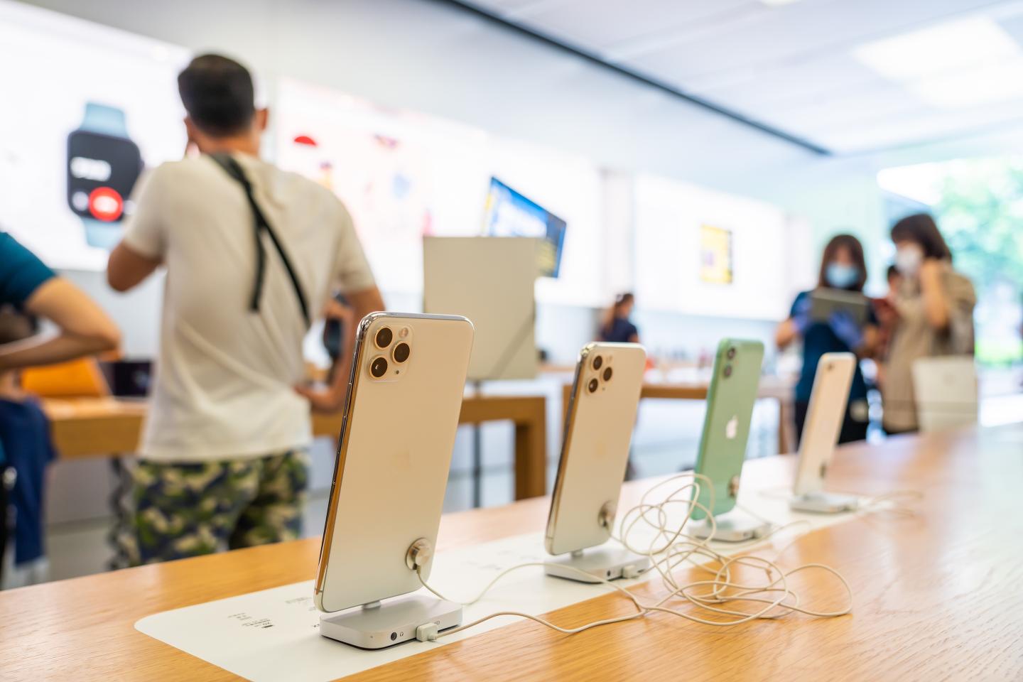 iPhone 11 series smartphones displayed at an Apple retail