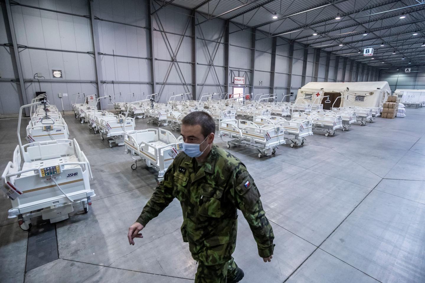 Member of the Czech Army walks past medical beds inside of field hospital built in an exhibition center for patients who suffer the coronavirus disease on October 22, 2020 in Prague, Czech Republic.