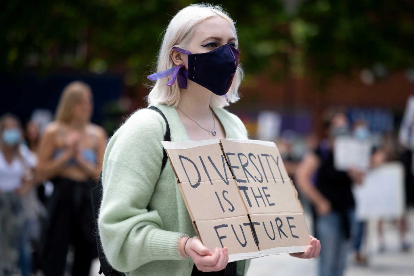 A protester holds a sign saying "diversity is the future" during a Black Lives Matter protest at Kings Square on June 13, 2020 in Barry, United Kingdom.