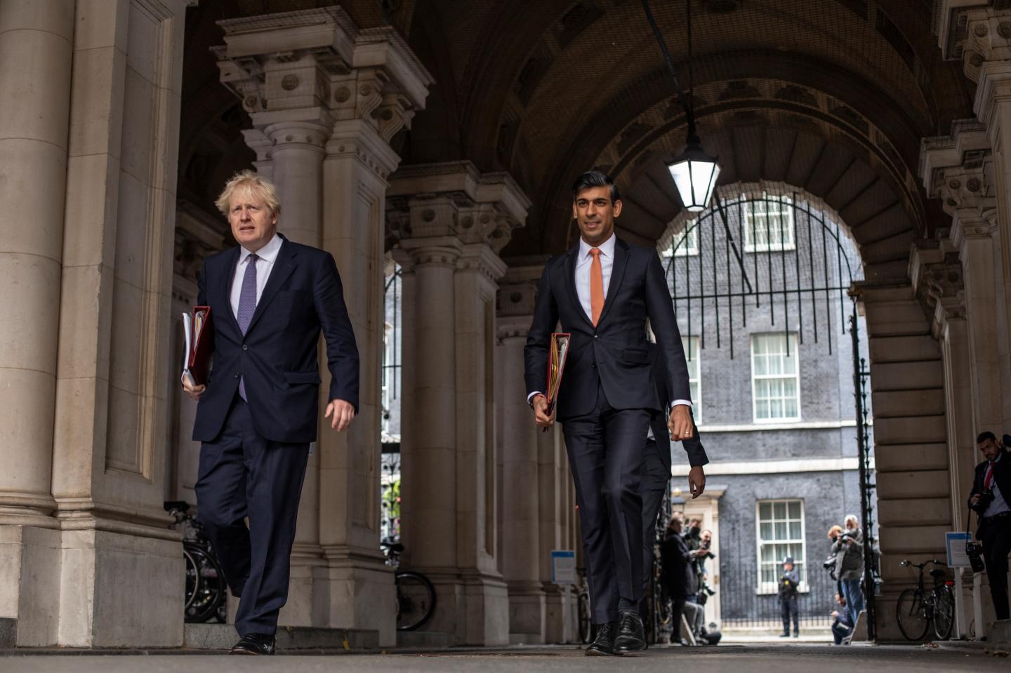 British Prime Minister Boris Johnson and Chancellor Rishi Sunak head to the weekly cabinet meeting at the British Foreign and Commonwealth Office on October 13, 2020 in London, England.