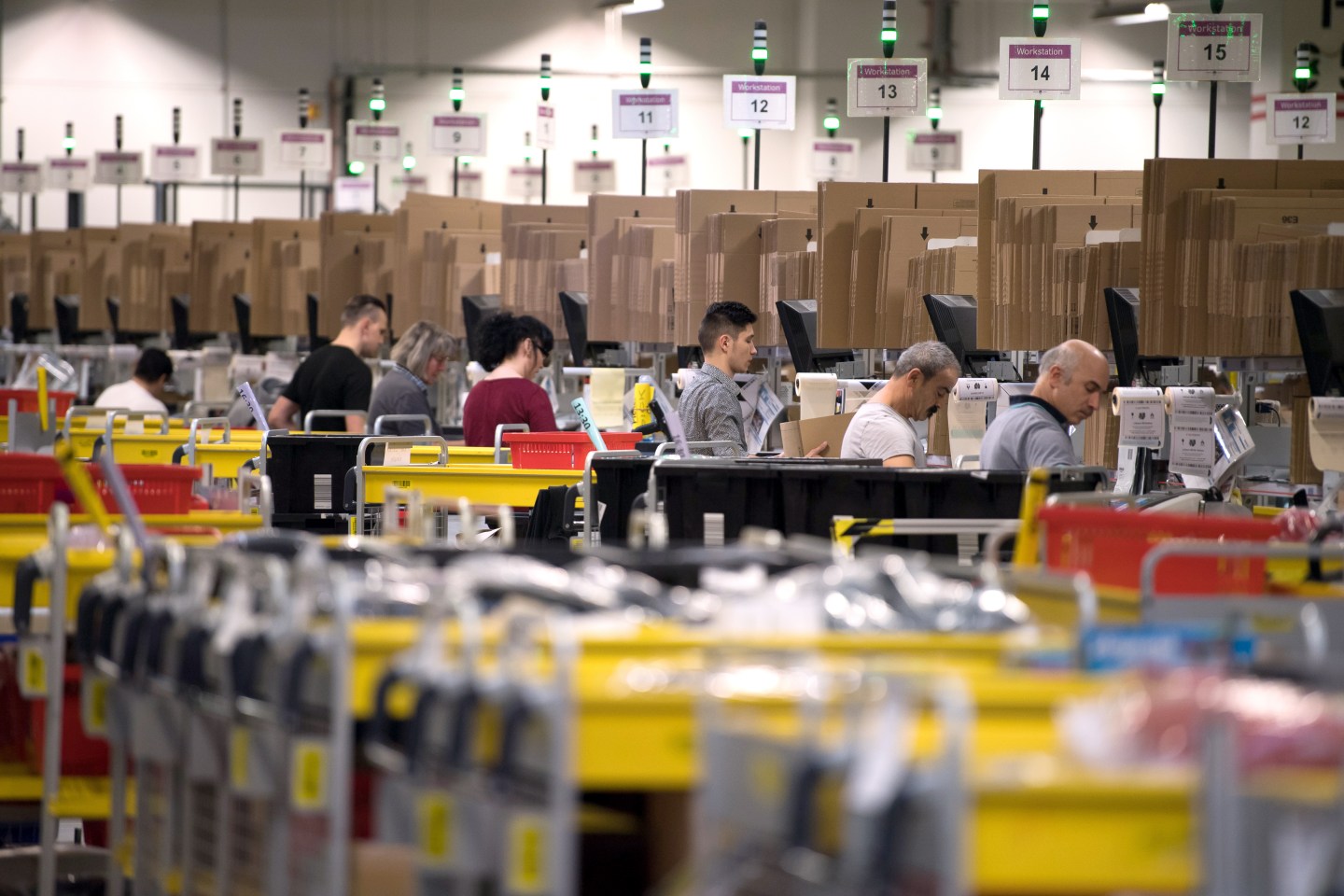 Employees ready mail order items for shipment during open media day of the electronic commerce giant Amazon, in Bad Hersfeld, Germany, 7 December 2017.