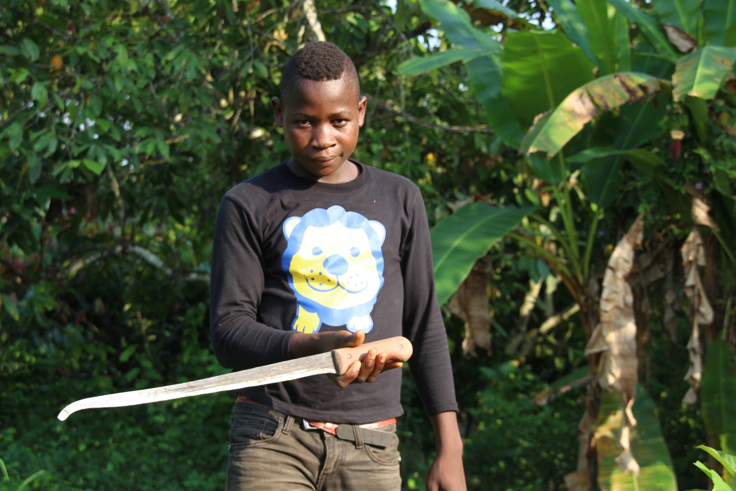A former child plantation laborer in Ivory Coast shows the machete he used for the cocoa harvest. The use of child labor remains widespread on West African cocoa farms, according to a new report from the U.S. Department of Labor.