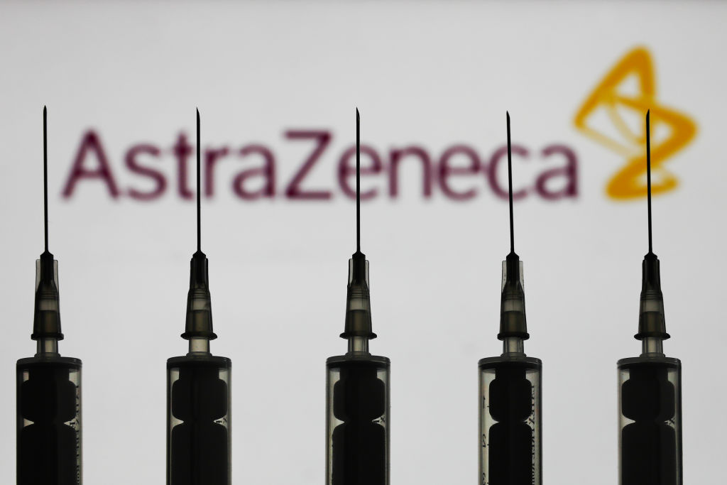 A line of syringes shown in silhouette against the AstraZeneca corporate logo.