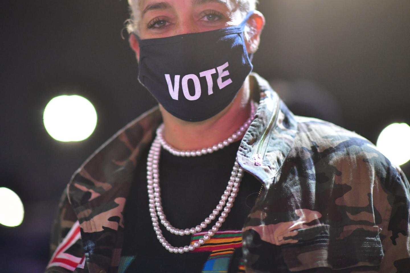 Kristen Hart, 47, wears a "VOTE" mask before Democratic vice presidential nominee Sen. Kamala Harris (D-CA) speaks at a drive-in election eve rally on November 2, 2020 in Philadelphia, Pennsylvania.