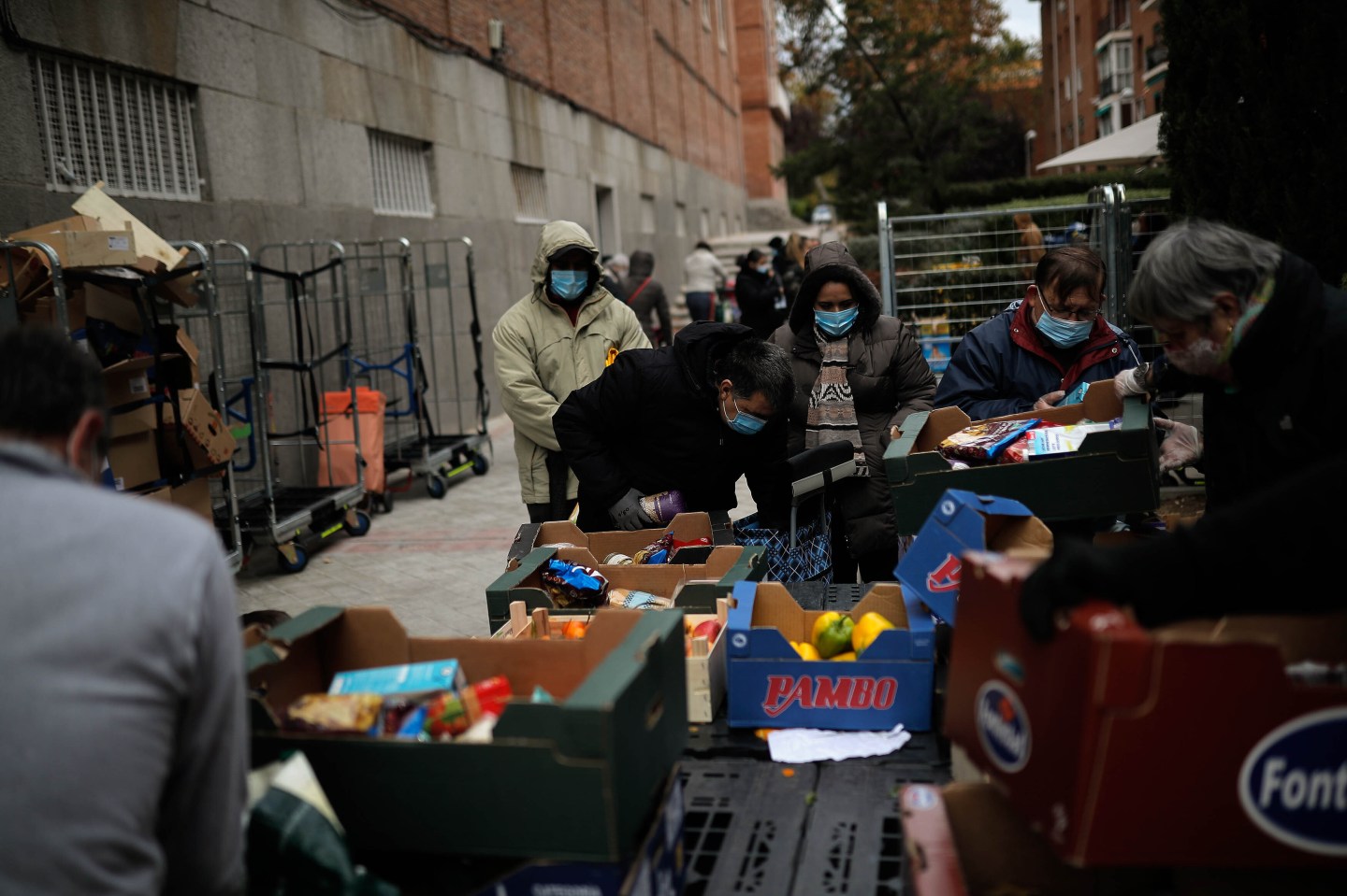 People wait in line to receive food donation due increasing unemployment and poverty as Spanish economy hit hard by the coronavirus (Covid-19) pandemic in Madrid, Spain on November 04, 2020.