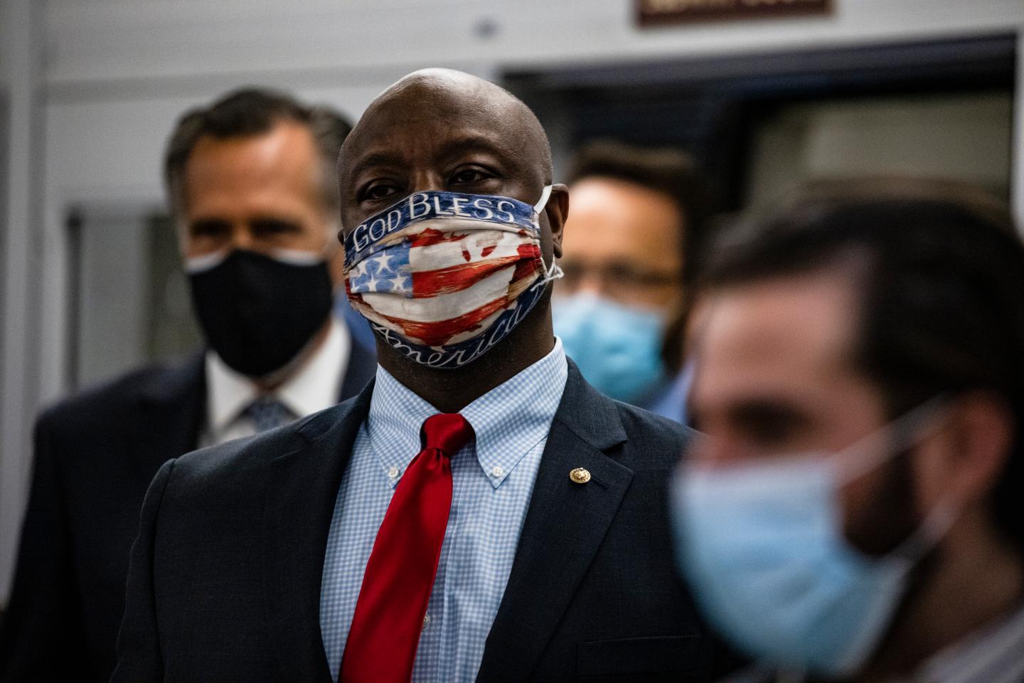 Senators Tim Scott (R-SC) (R) and Mitt Romney (R-UT) (L) step off the Senate subway on their way to a vote in the Senate at the U.S. Capitol on November 12, 2020 in Washington, DC. As President Trump continues to refuse to concede the Presidential Election to President-elect Joe Biden more Congressmen and women call for Biden to begin to receive classified national intelligence briefings from the Trump administration.
