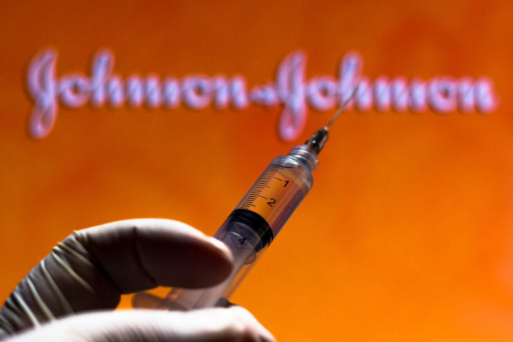 In this photo illustration a medical syringe is seen with