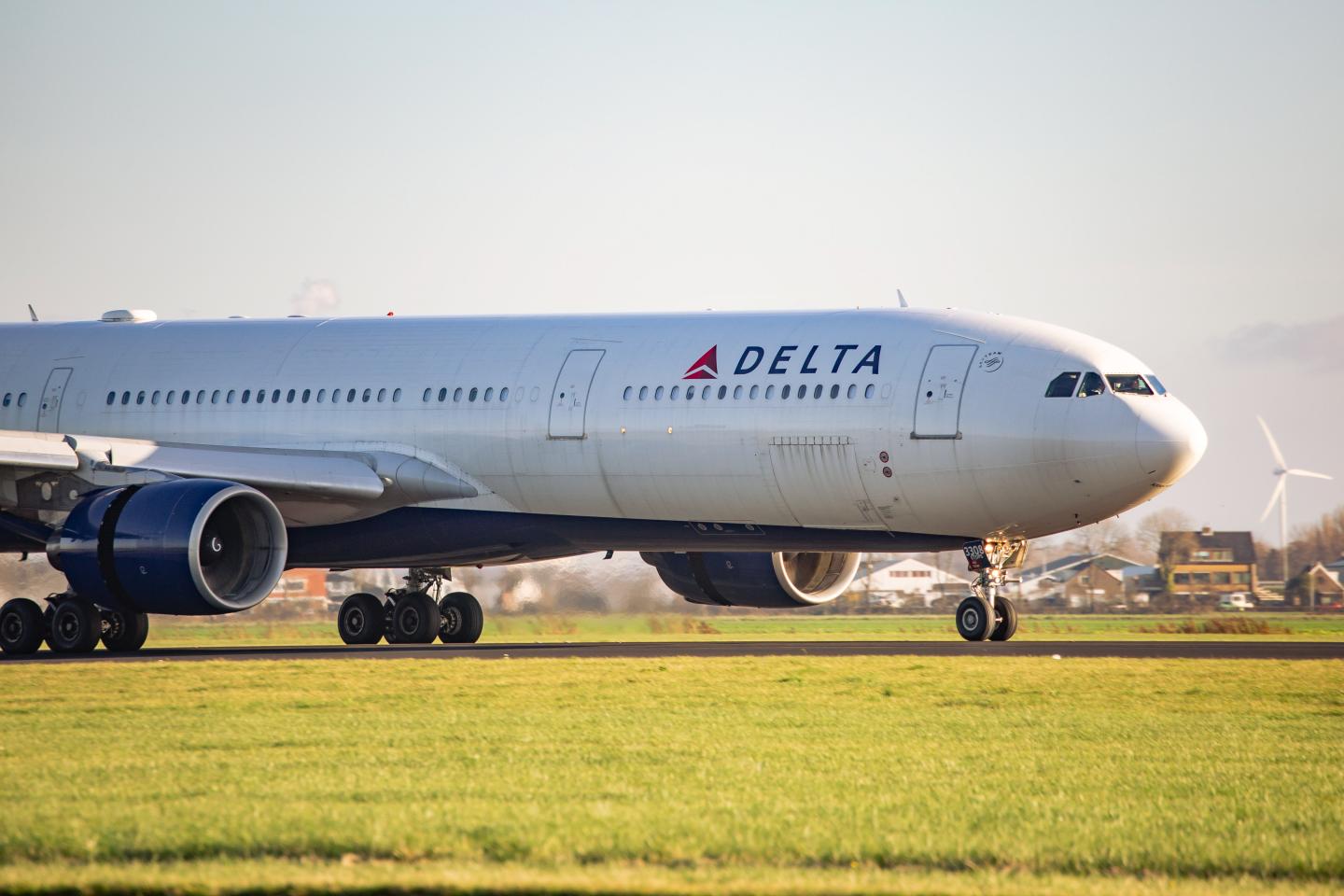 Delta Air Lines Airbus A330 aircraft as seen on final approach flying, landing and taxiing after touch down in Amsterdam Schiphol EHAM AMS International Airport in the Netherlands.