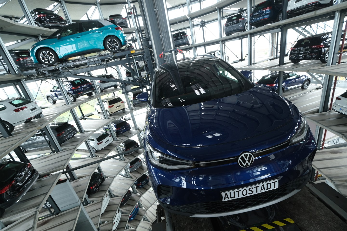 Volkswagen ID.4 (R) and ID.3 electric cars stand on elevator platforms inside one of the twin towers used as storage at the Autostadt promotional facility next to the Volkswagen factory on October 26, 2020 in Wolfsburg, Germany. The ID.3 and ID.4 are Volkswagen's first real effort to break into the growing electric car market and are aimed for mass appeal.