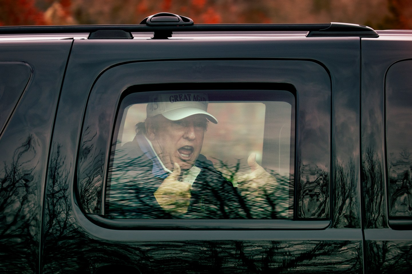 President Trump greets supporters from his motorcade after golfing on Sunday, Nov. 22 at Trump National Golf Club in Sterling, Va.