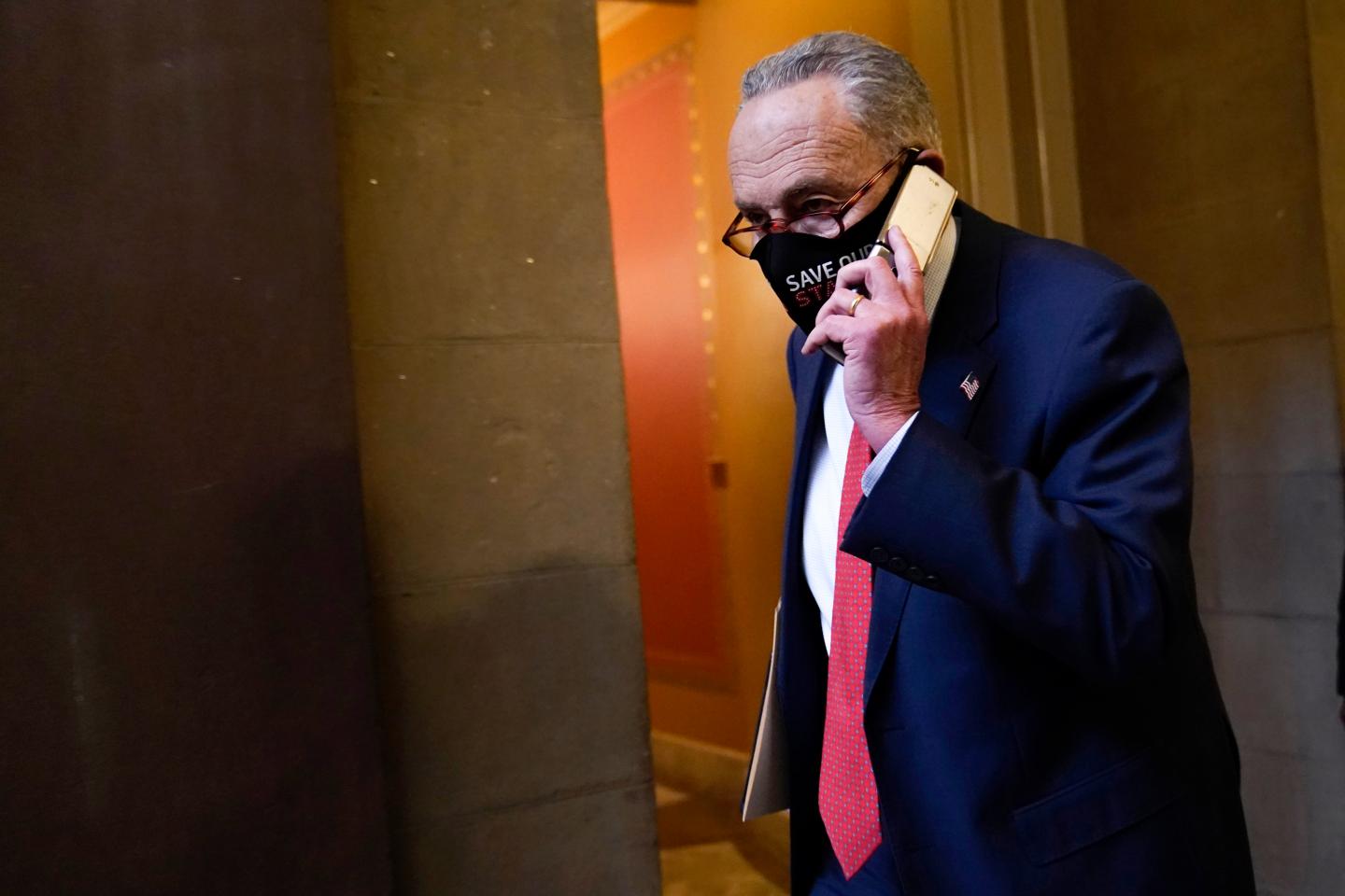 Senate Minority Leader Sen. Chuck Schumer of N.Y., walks on Capitol Hill in Washington, Tuesday, Dec. 15, 2020. 