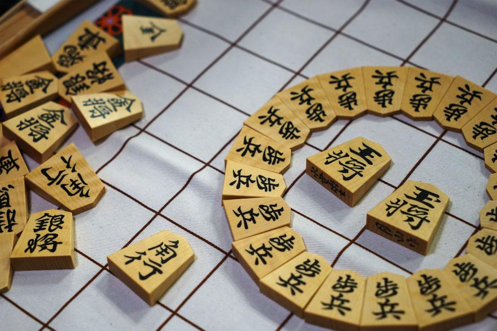 Picture of Shogi game tiles arranged on a board.