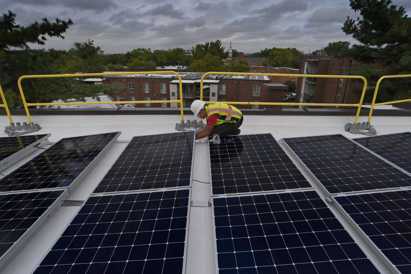 WASHINGTON, DC-AUGUST 27: Naomi Hawk works on a job site installing solar panels on the roof of an apartment complex in SE Washington D.C. on August 27, 2019. Hawk is a graduate of the Solar Works DC training program that ended earlier this summer. Hawk is now doing on site jobs for the New Columbia Solar company. (Photo by Michael S. Williamson/The Washington Post via Getty Images)
