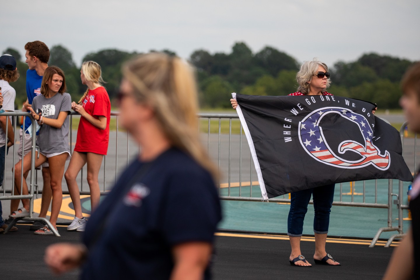 An attendee holds a QAnon flag before a campaign rally for U.S. President Donald Trump in Winston-Salem, North Carolina, U.S., on Tuesday, Sept. 8, 2020.