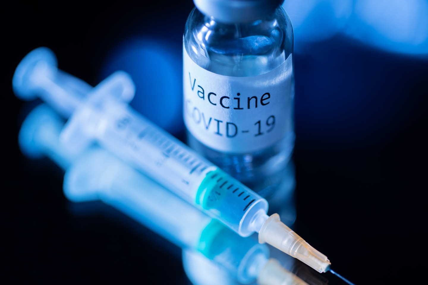 This picture taken on November 17, 2020 shows a syringe and a bottle reading "Vaccine Covid-19".