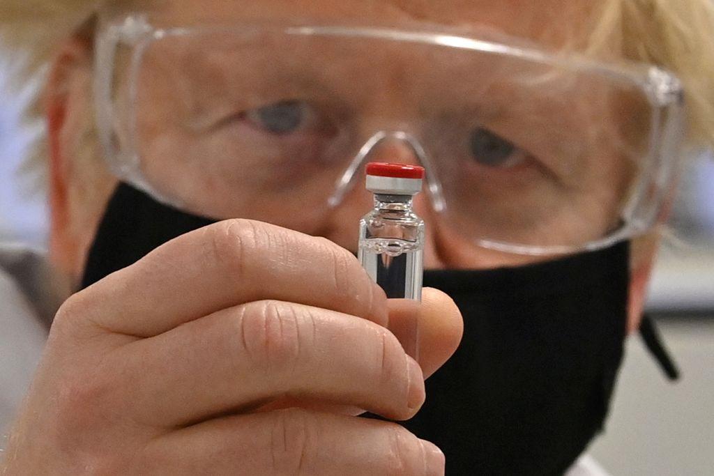 U.K. Prime Minister Boris Johnson holding a vial of AstraZeneca's Covid-19 vaccine.