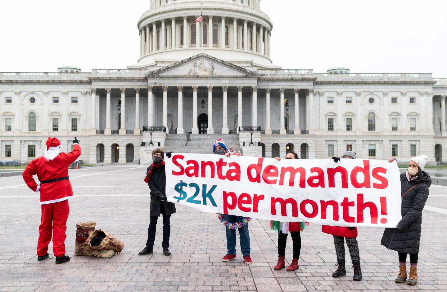 Metro DC Socialists hold a Christmas morning photo op for Santa to deliver coal to Congress while demanding a $2,000 per month check on Friday, Dec. 25, 2020.