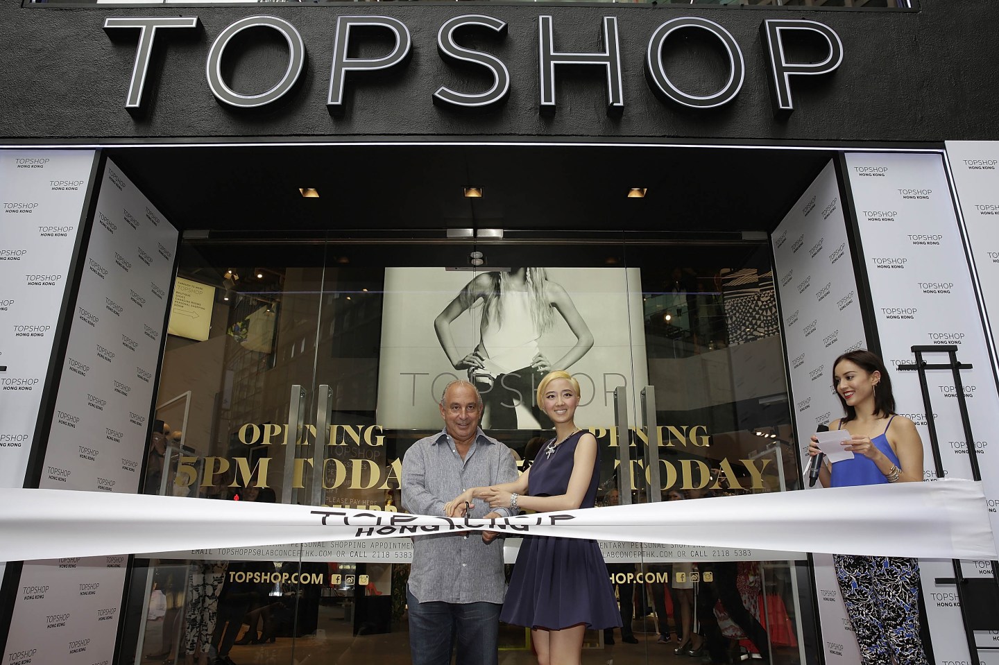 Sir Philip Green the owner of Topshop and Taiwanese actress Gwei Lun Mei cut a ribbon to mark the opening of the new Topshop store as TV host Mandy Lieu watches on June 6, 2013 in Hong Kong.