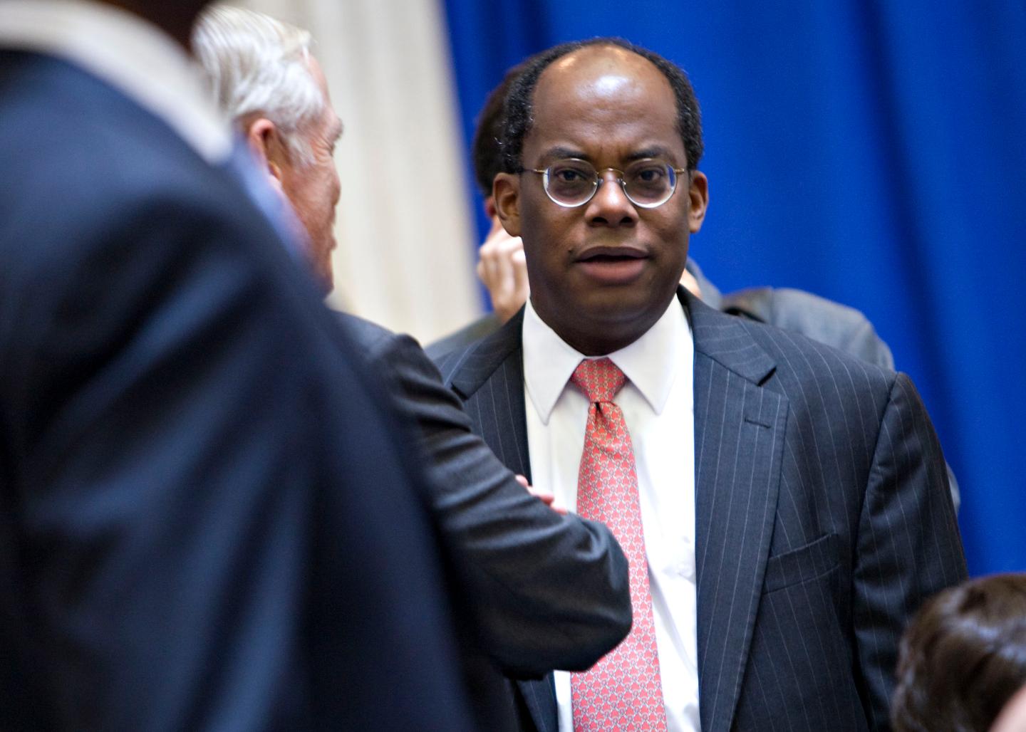 Roger Ferguson, president and chief executive officer of TIAA-CREF, right, speaks with William Donaldson, chairman of the Securities and Exchange Commission from 2003-2005, left partially obscured, prior to a speech by U.S. President Barack Obama at Federal Hall National Memorial in New York, U.S., on Monday, Sept. 14, 2009.