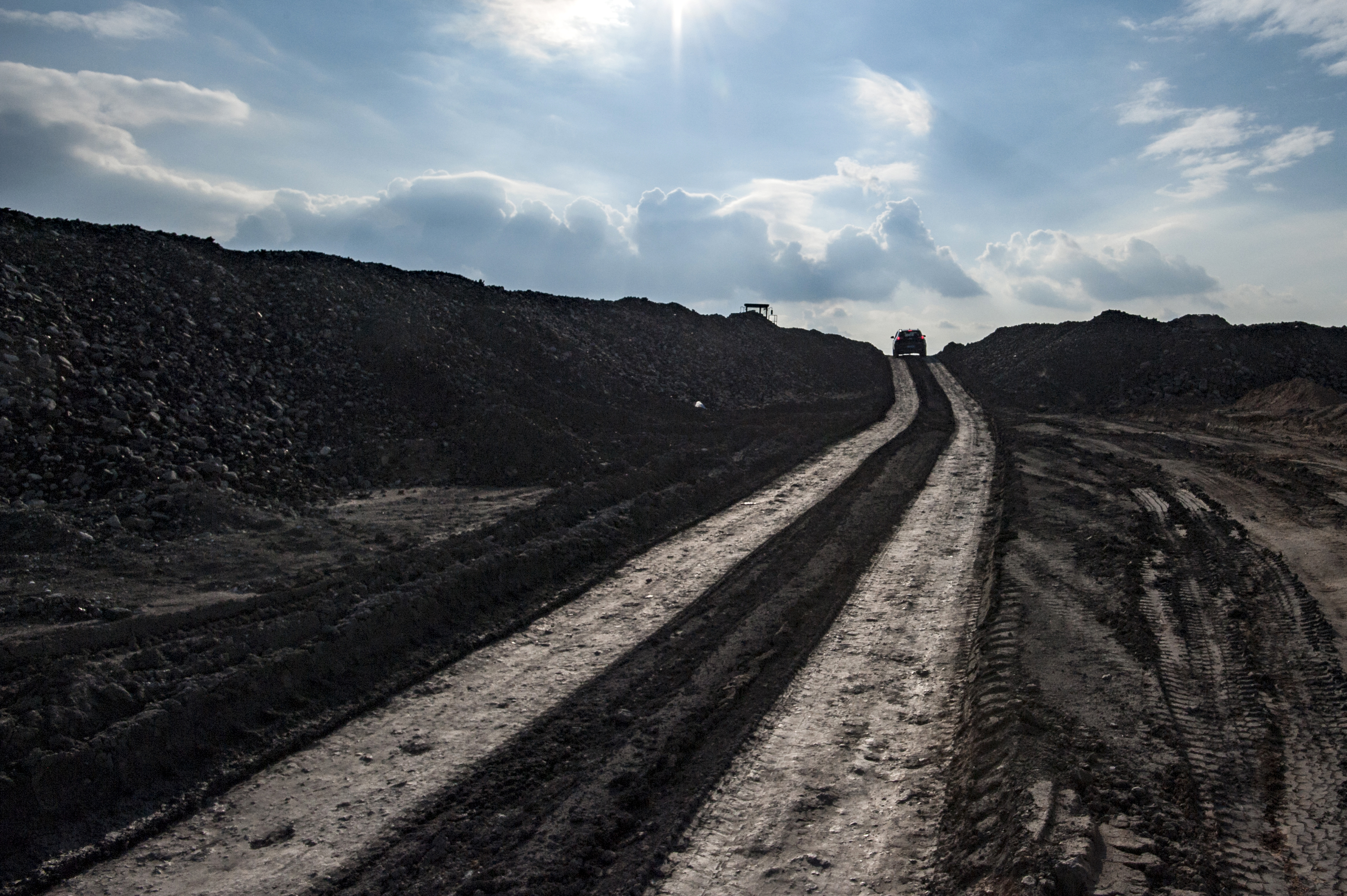 A car is driven past a coal waste pile outside a coal mine operated by Beijing Haohua Energy Resource Co., Ltd on September 20, 2019 in Ordos, Inner Mongolia Autonomous Region of China. 