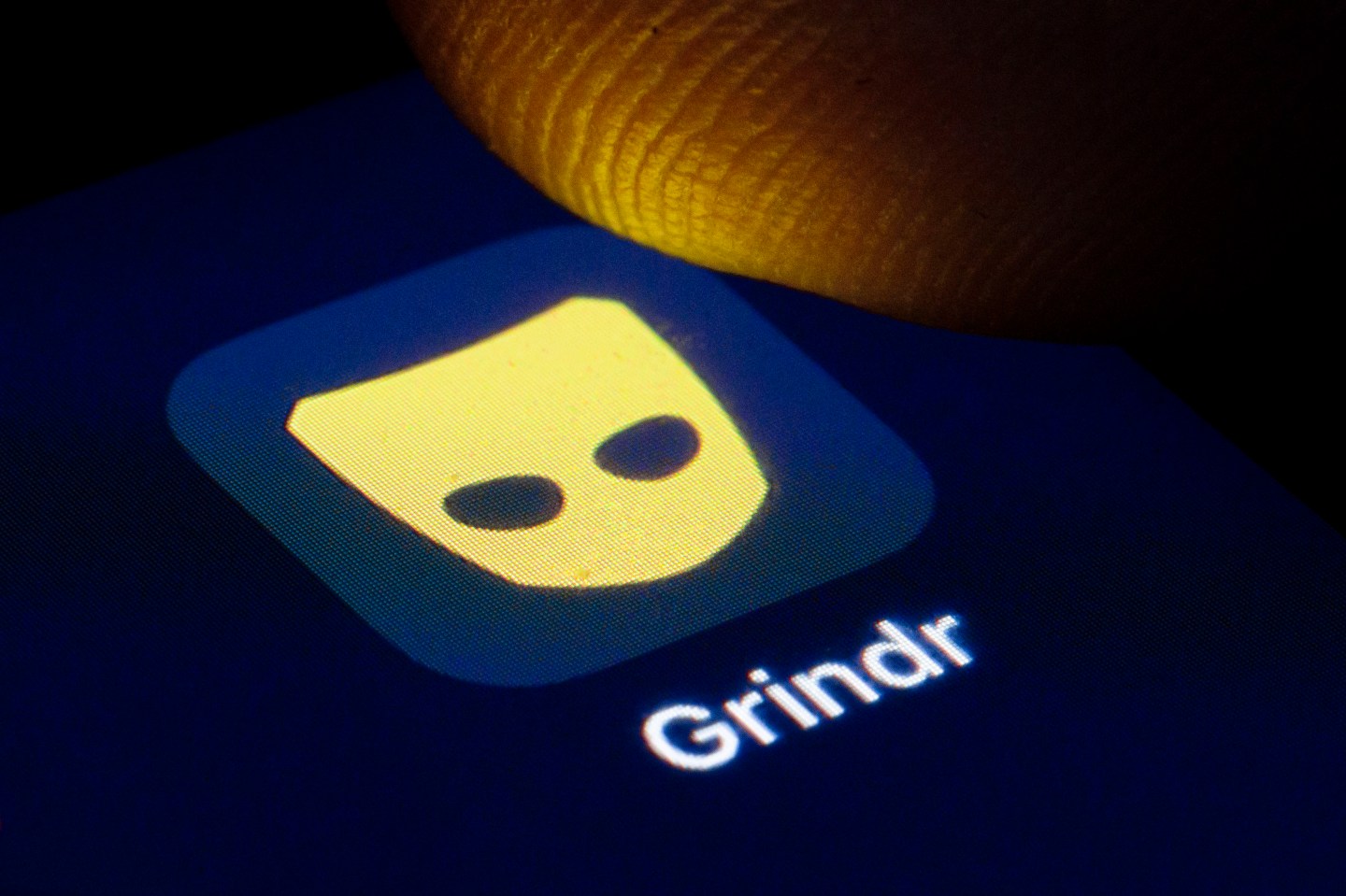 The logo of the dating app for gay and bisexual men Grindr is shown on the display of a smartphone on April 22, 2020 in Berlin, Germany.