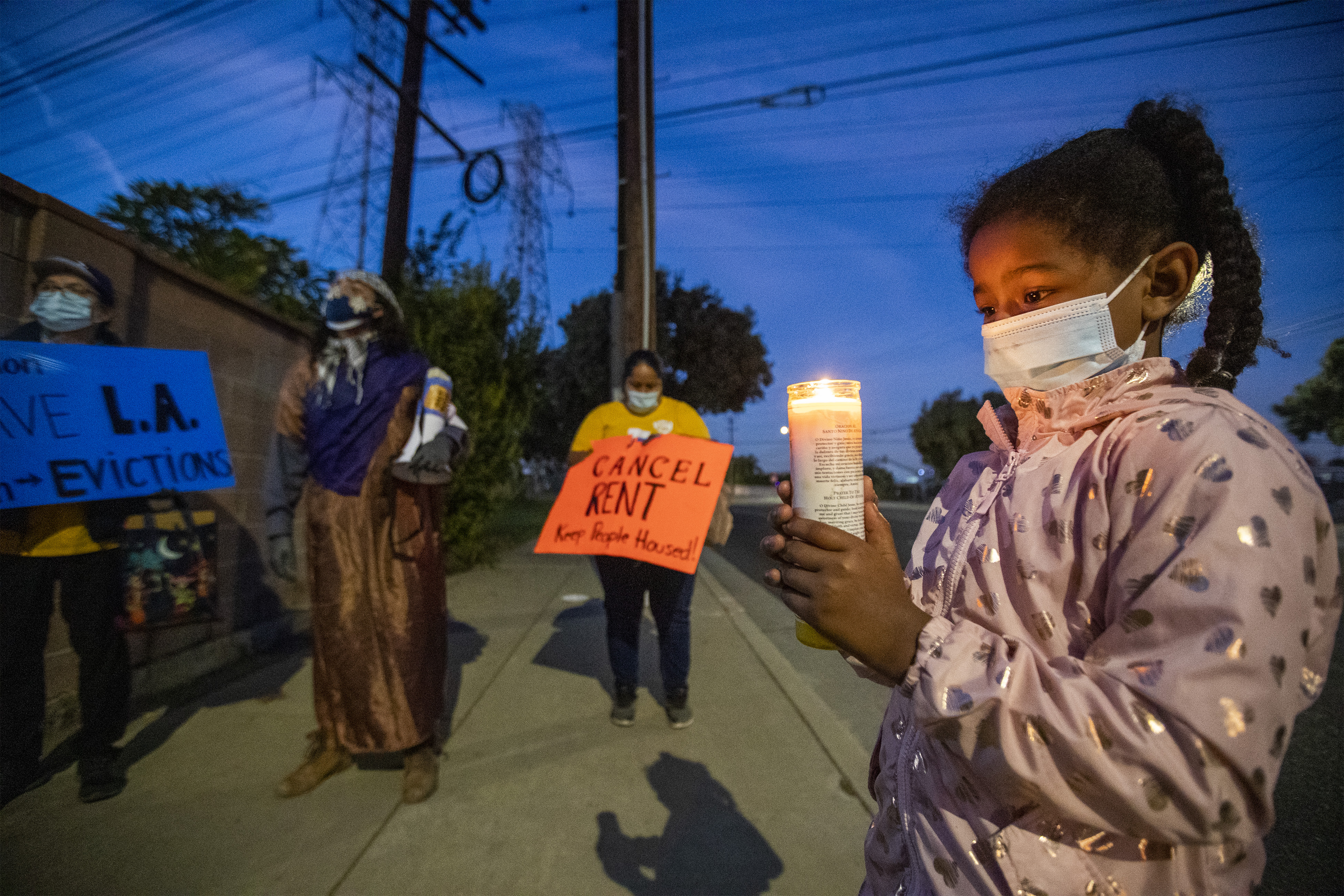 Los Angeles area residents take part in a protest for tenants in danger of eviction because of the fallout of the coronavirus pandemic, on Dec. 16, 2020, in Lakewood, Calif.