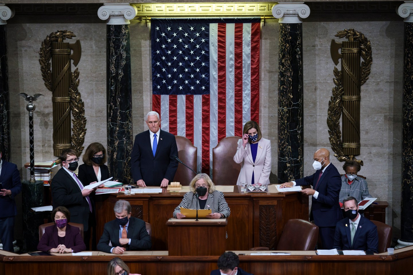Vice President Mike Pence and Speaker of the House Nancy Pelosi, D-Calif., prepare to read the final certification of Electoral College votes cast in November's presidential election during a joint session of Congress after working through the night, at the Capitol on January 7, 2021 in Washington, DC.