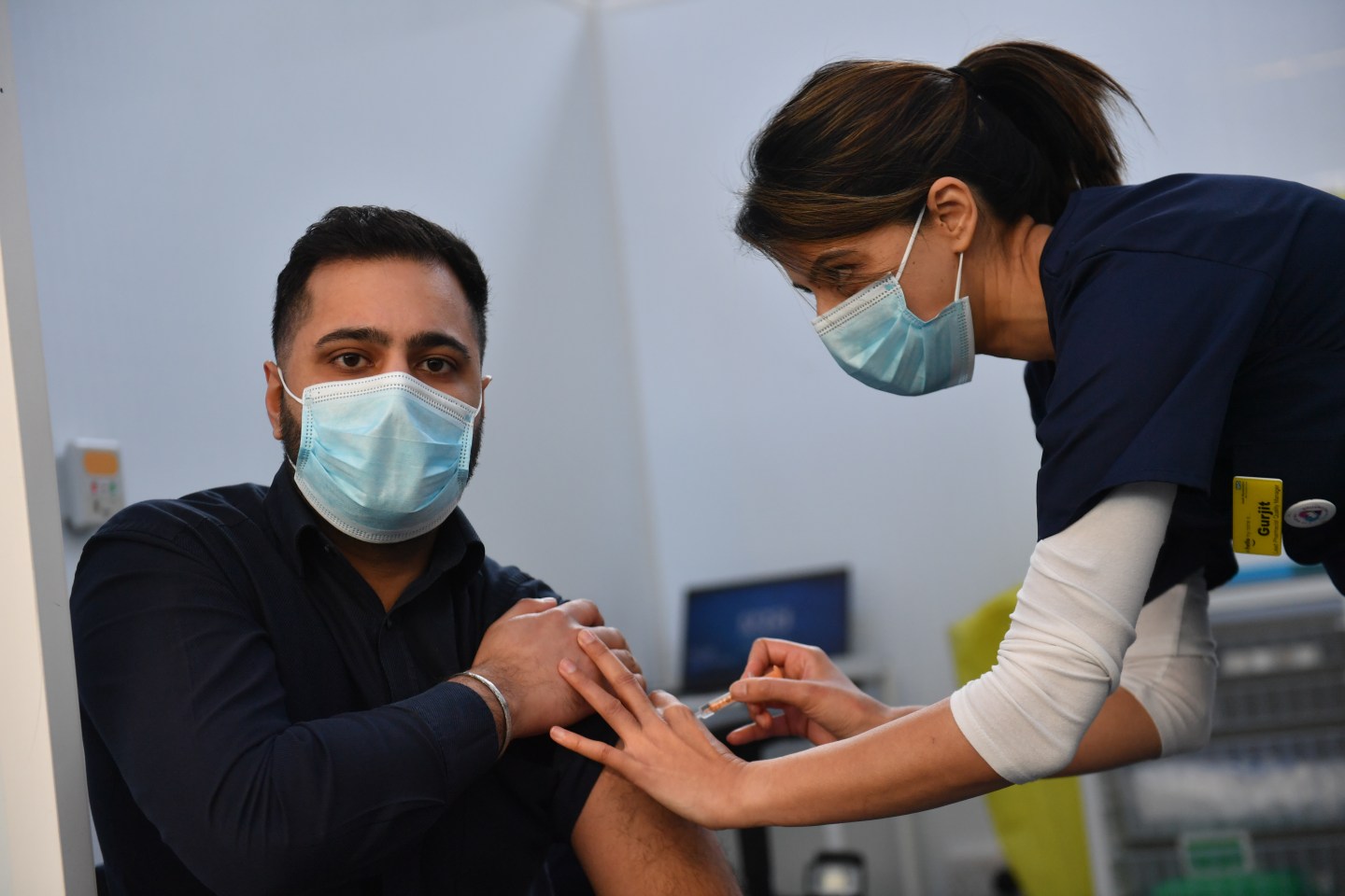 Pharmacist Josh Athwal (left) receives an injection of the Oxford/Astrazeneca coronavirus vaccine, administered by nurse Gurit Dhadday, at The Black Country Living Museum in Dudley.
