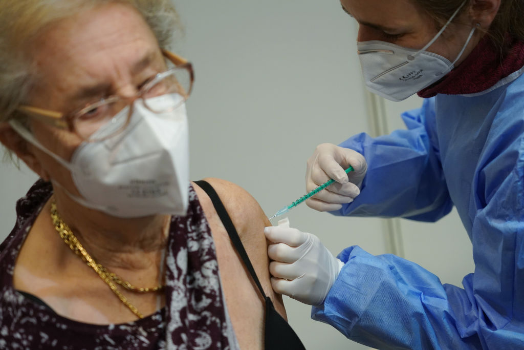 An older woman receiving an injection